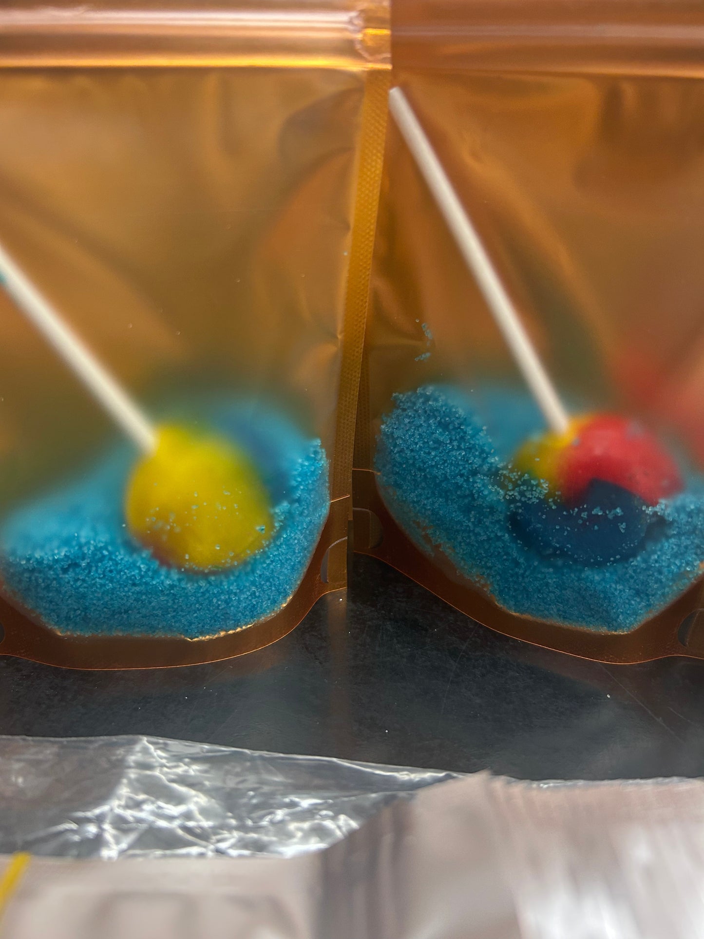 Raspberry flavoured blue sugar crystals with a free lollipop