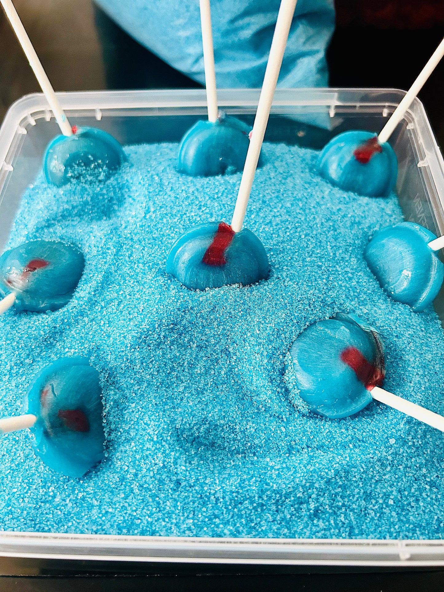Raspberry flavoured blue sugar crystals with a free lollipop